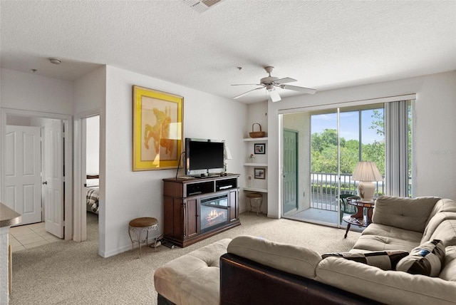 living room with a textured ceiling, ceiling fan, and light carpet