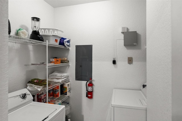 laundry area featuring electric panel and washing machine and dryer