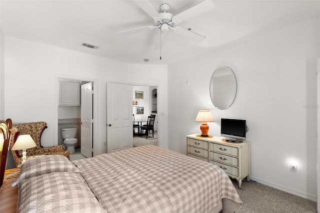 bedroom with light colored carpet, ceiling fan, and ensuite bathroom