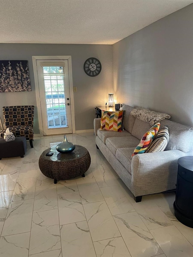 living room with tile patterned flooring and a textured ceiling