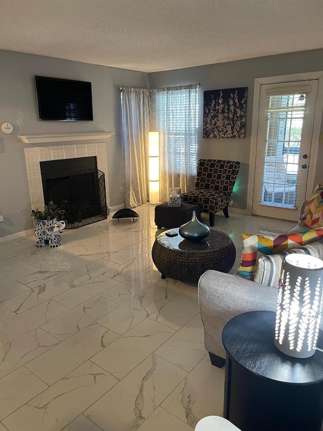 tiled living room with a fireplace and a textured ceiling