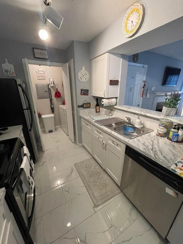 kitchen featuring stainless steel dishwasher, white cabinets, stove, and light tile patterned flooring