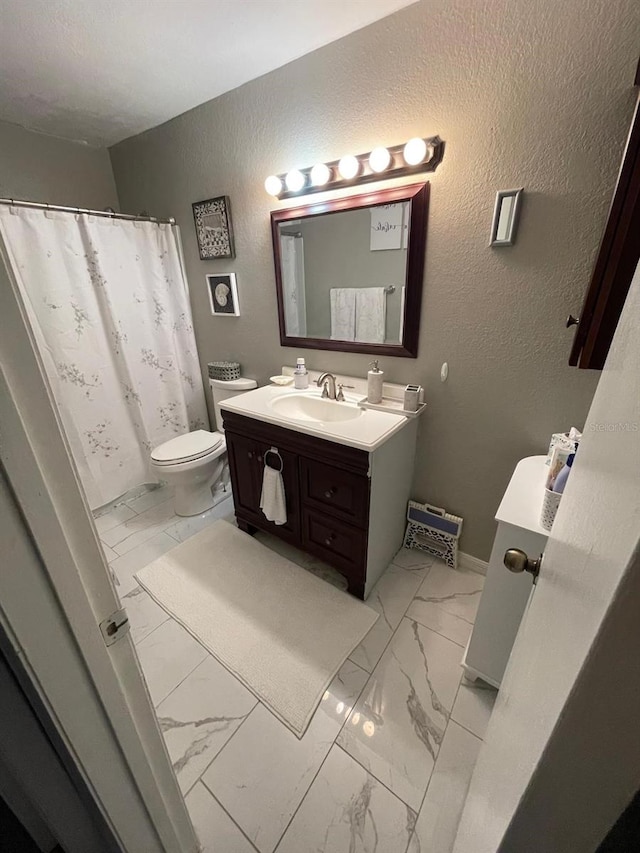 bathroom featuring vanity, tile patterned flooring, and toilet