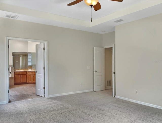 empty room with light carpet, ceiling fan, and sink