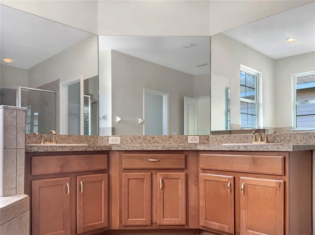 bathroom featuring vanity and an enclosed shower