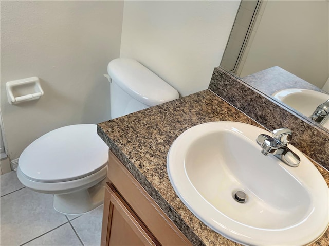 bathroom with tile patterned floors, vanity, and toilet