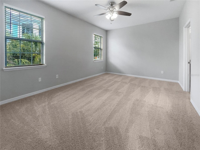 carpeted empty room featuring ceiling fan