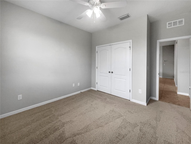 unfurnished bedroom with carpet floors, a closet, and ceiling fan