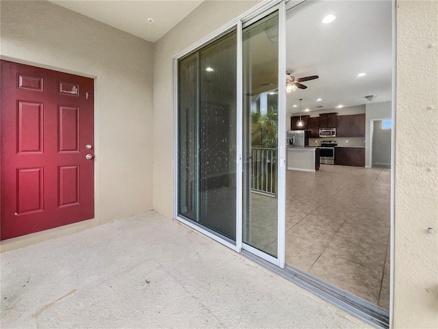 entrance to property featuring a patio