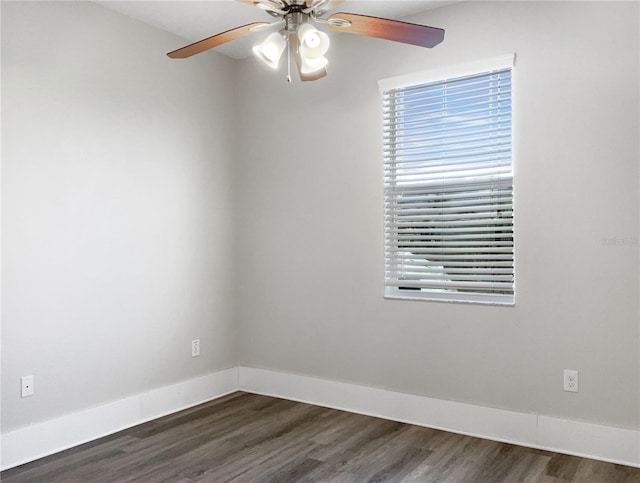 empty room featuring ceiling fan, dark wood-style flooring, and baseboards