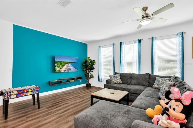 living room with wood-type flooring and ceiling fan