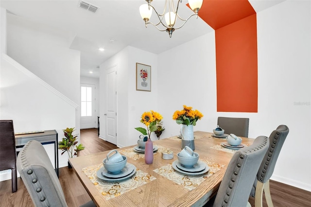 dining space with a chandelier and dark hardwood / wood-style floors