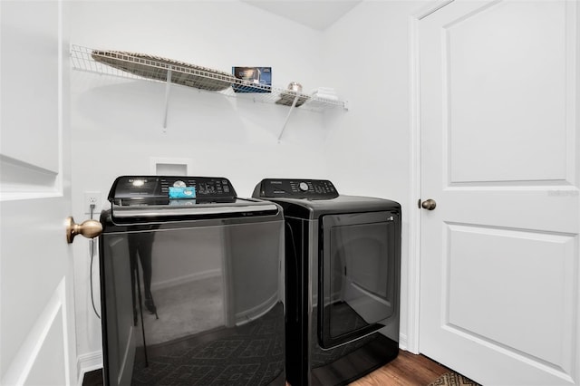 laundry room featuring independent washer and dryer and hardwood / wood-style floors