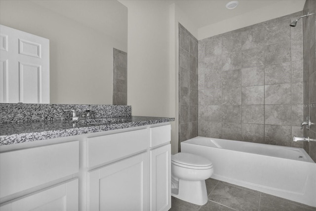 full bathroom with vanity, tiled shower / bath, tile patterned flooring, and toilet