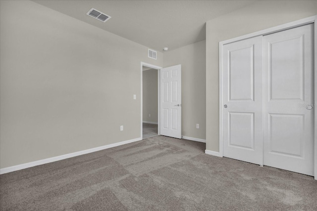 unfurnished bedroom with a closet and carpet flooring