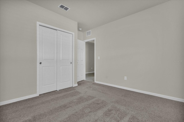 unfurnished bedroom featuring a closet and carpet floors