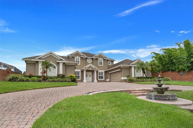 view of front of home featuring a garage and a front lawn