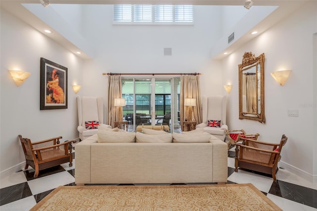 living room featuring tile patterned flooring and a towering ceiling