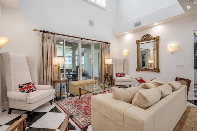 living room with a high ceiling and plenty of natural light