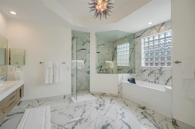 bathroom featuring vanity, tile walls, separate shower and tub, a raised ceiling, and tile patterned flooring