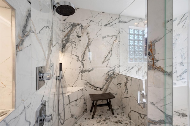 bathroom with tiled shower and tile walls