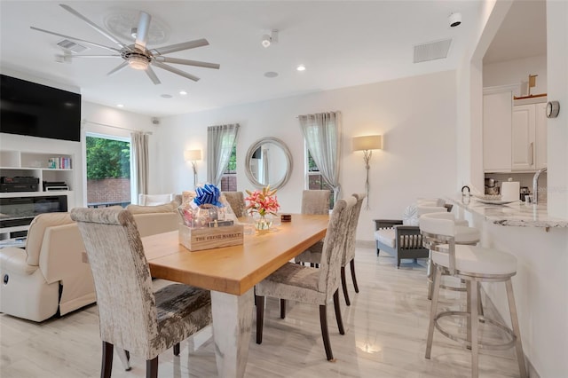 dining area featuring light wood-type flooring and ceiling fan