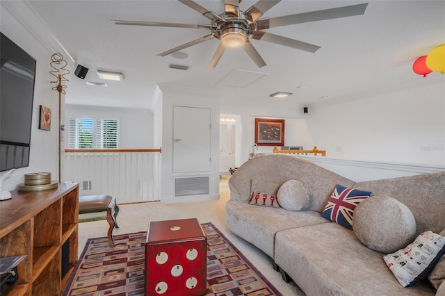 carpeted living room featuring ornamental molding and ceiling fan