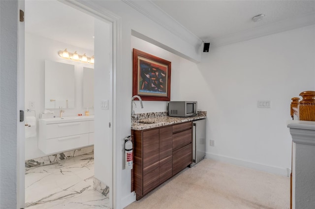 bathroom with vanity and ornamental molding