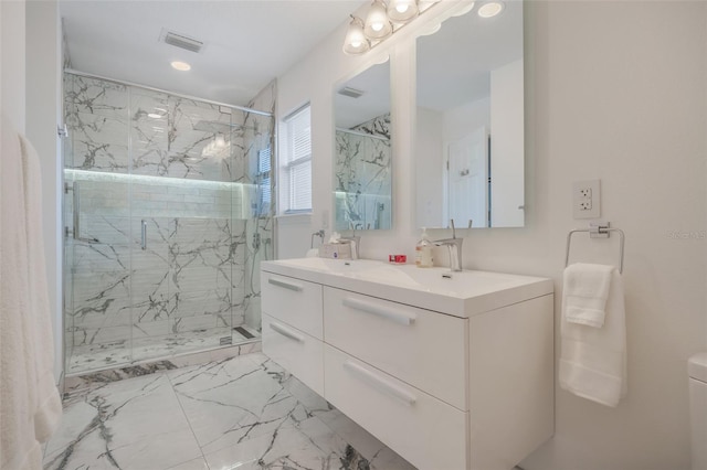 bathroom featuring a shower with door, tile patterned flooring, and double sink vanity