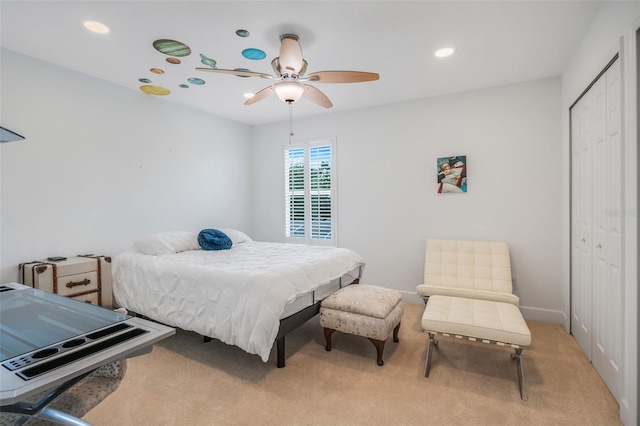 carpeted bedroom with a closet and ceiling fan