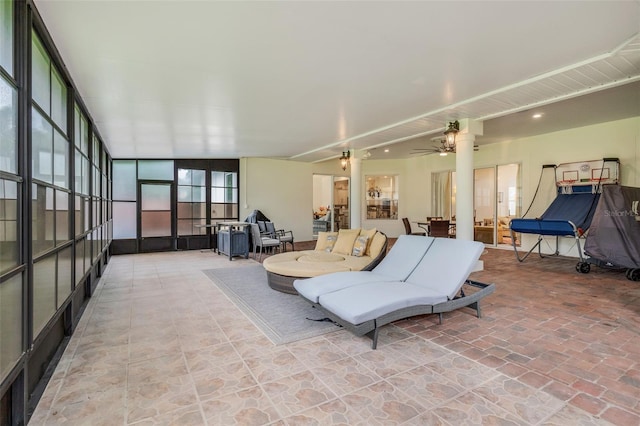 sunroom / solarium featuring ceiling fan