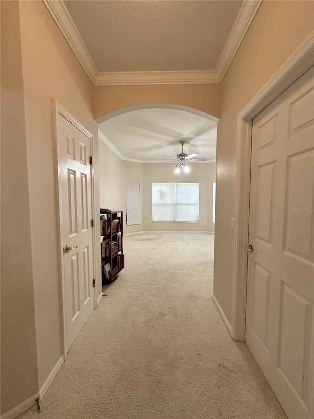 681 Coronado Dr, Kissimmee, FL 34759 - hall featuring light carpet, baseboards, arched walkways, and ornamental molding