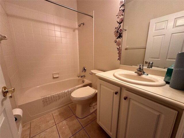 681 Coronado Dr, Kissimmee, FL 34759 - bathroom with toilet, tile patterned flooring, vanity, and shower / bathtub combination