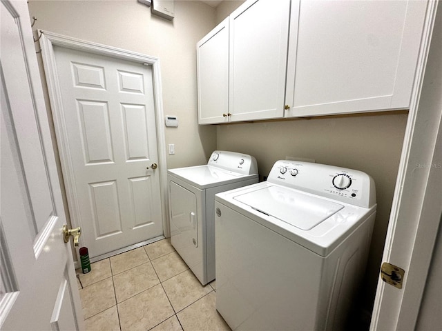 681 Coronado Dr, Kissimmee, FL 34759 - laundry area featuring cabinet space, independent washer and dryer, and light tile patterned floors
