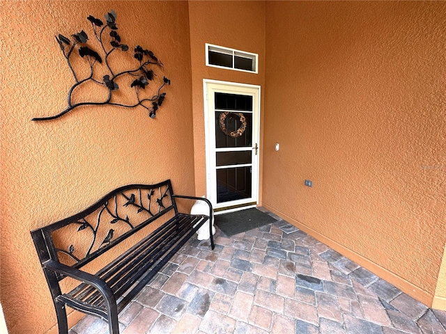 681 Coronado Dr, Kissimmee, FL 34759 - property entrance featuring stucco siding and a patio