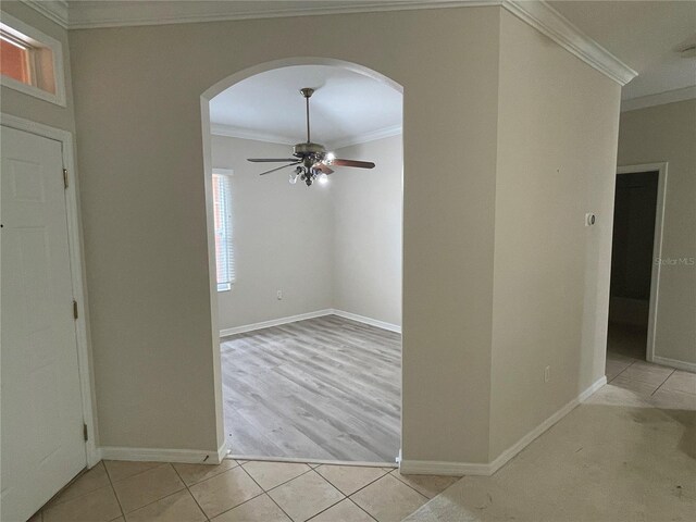 681 Coronado Dr, Kissimmee, FL 34759 - foyer entrance featuring arched walkways, ornamental molding, ceiling fan, and light tile patterned floors