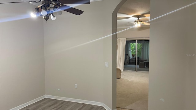681 Coronado Dr, Kissimmee, FL 34759 - empty room featuring ceiling fan, arched walkways, and wood finished floors