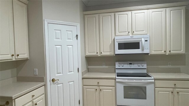 681 Coronado Dr, Kissimmee, FL 34759 - kitchen with white appliances, light countertops, and white cabinets