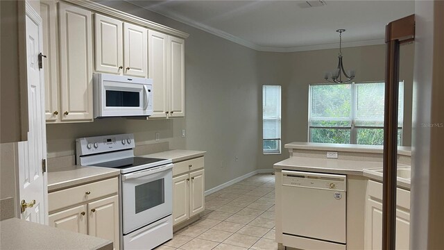 681 Coronado Dr, Kissimmee, FL 34759 - kitchen with white appliances, a chandelier, light countertops, light tile patterned floors, and ornamental molding