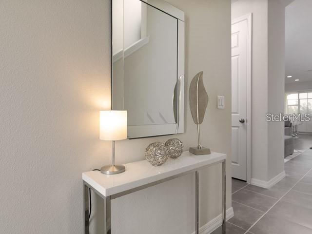 hallway featuring dark tile patterned floors