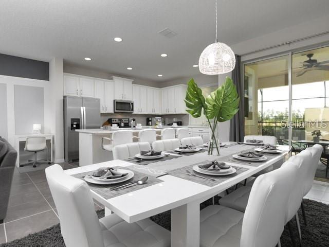 dining room with dark tile patterned flooring and ceiling fan