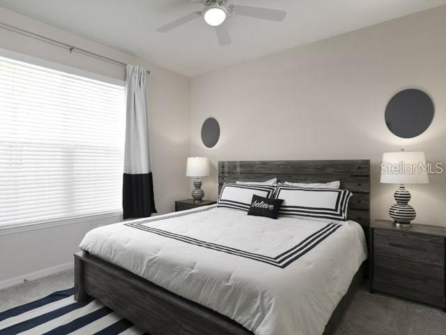 carpeted bedroom with ceiling fan