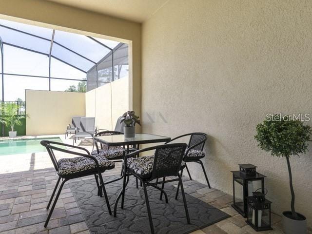 view of patio featuring a lanai