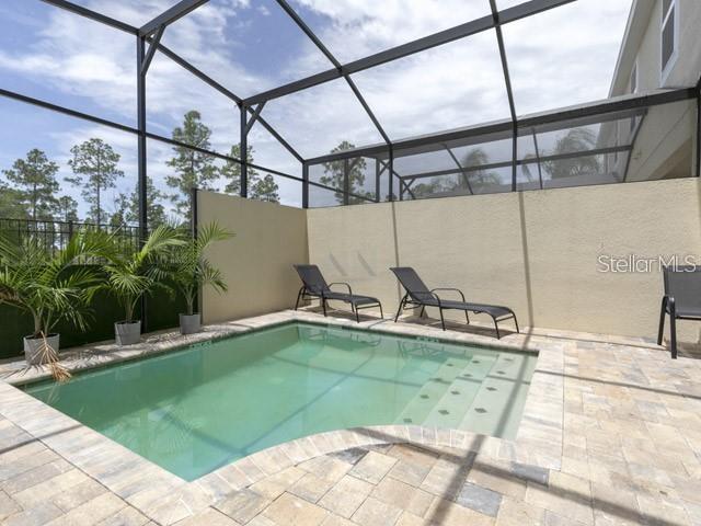 view of pool featuring a patio and a lanai