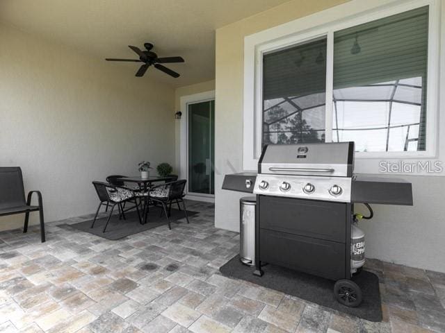 view of patio featuring area for grilling, a lanai, and ceiling fan