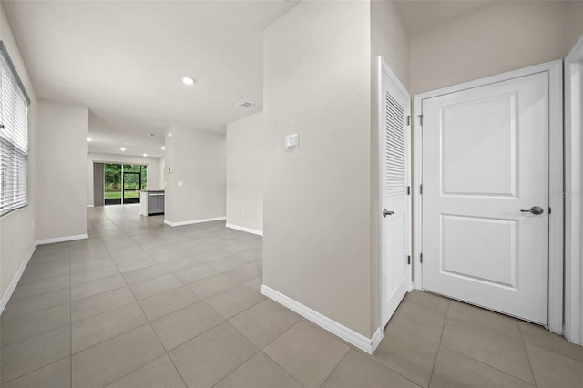 hallway with light tile patterned floors