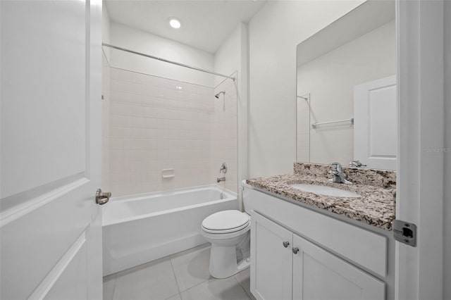 full bathroom with tiled shower / bath, tile patterned floors, toilet, and vanity