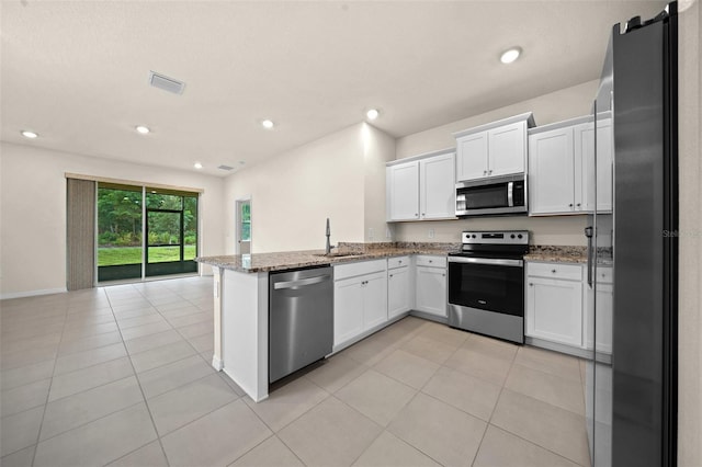 kitchen featuring white cabinetry, sink, light stone counters, kitchen peninsula, and stainless steel appliances