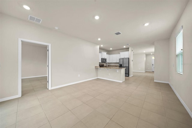 unfurnished living room featuring light tile patterned flooring