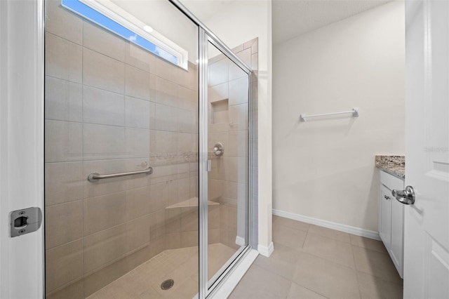 bathroom with vanity, an enclosed shower, and tile patterned flooring